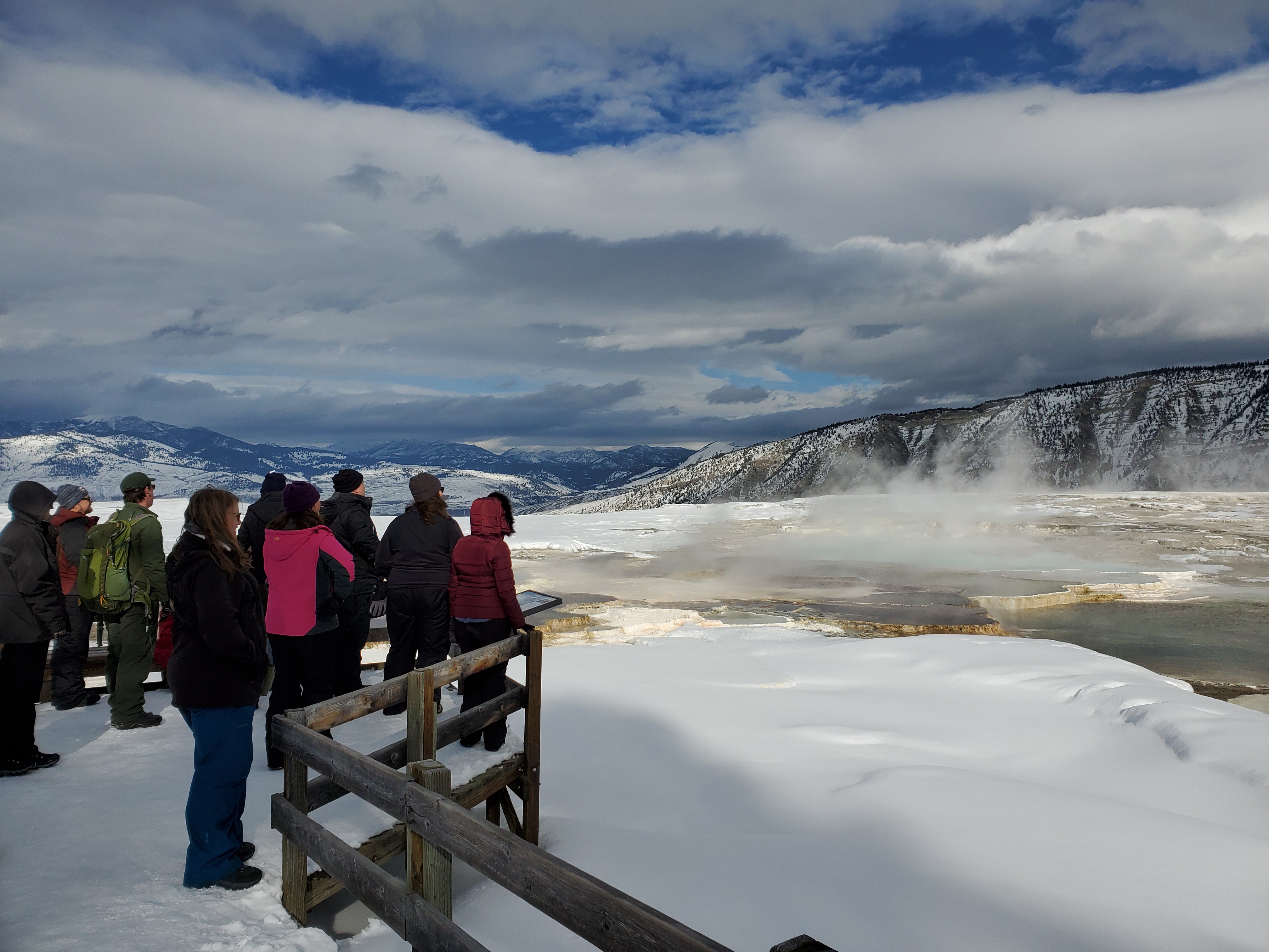 A group of people overlooking mammoth terraces