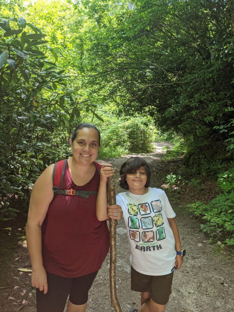 Teacher and her son hike in a mountain forest along the Blue Ridge Parkway