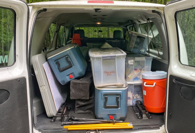 large van packed full of bins and coolers