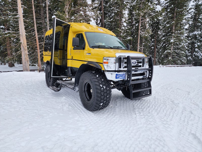 a snowcoach - large yellow van with giant tires