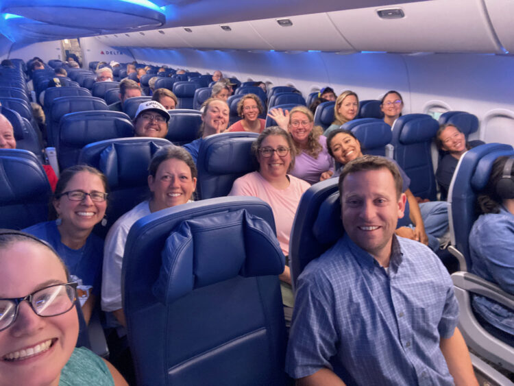 A group of people sitting in seats on a plane