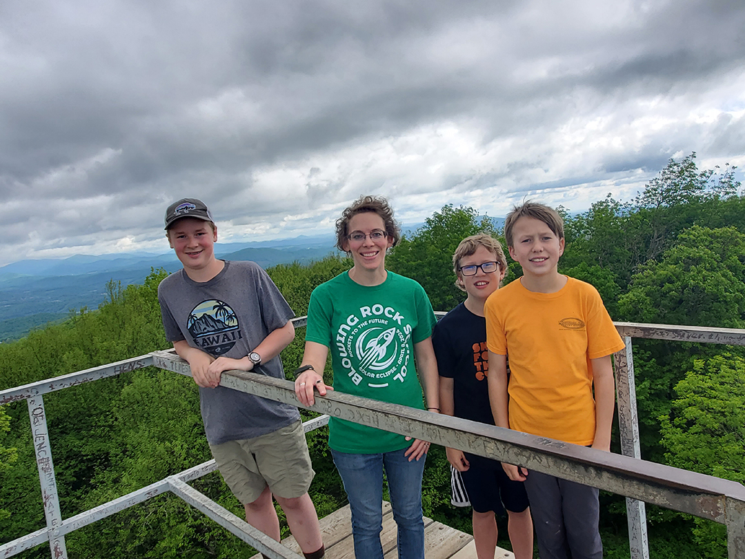 teacher and 3 students on a fire tower