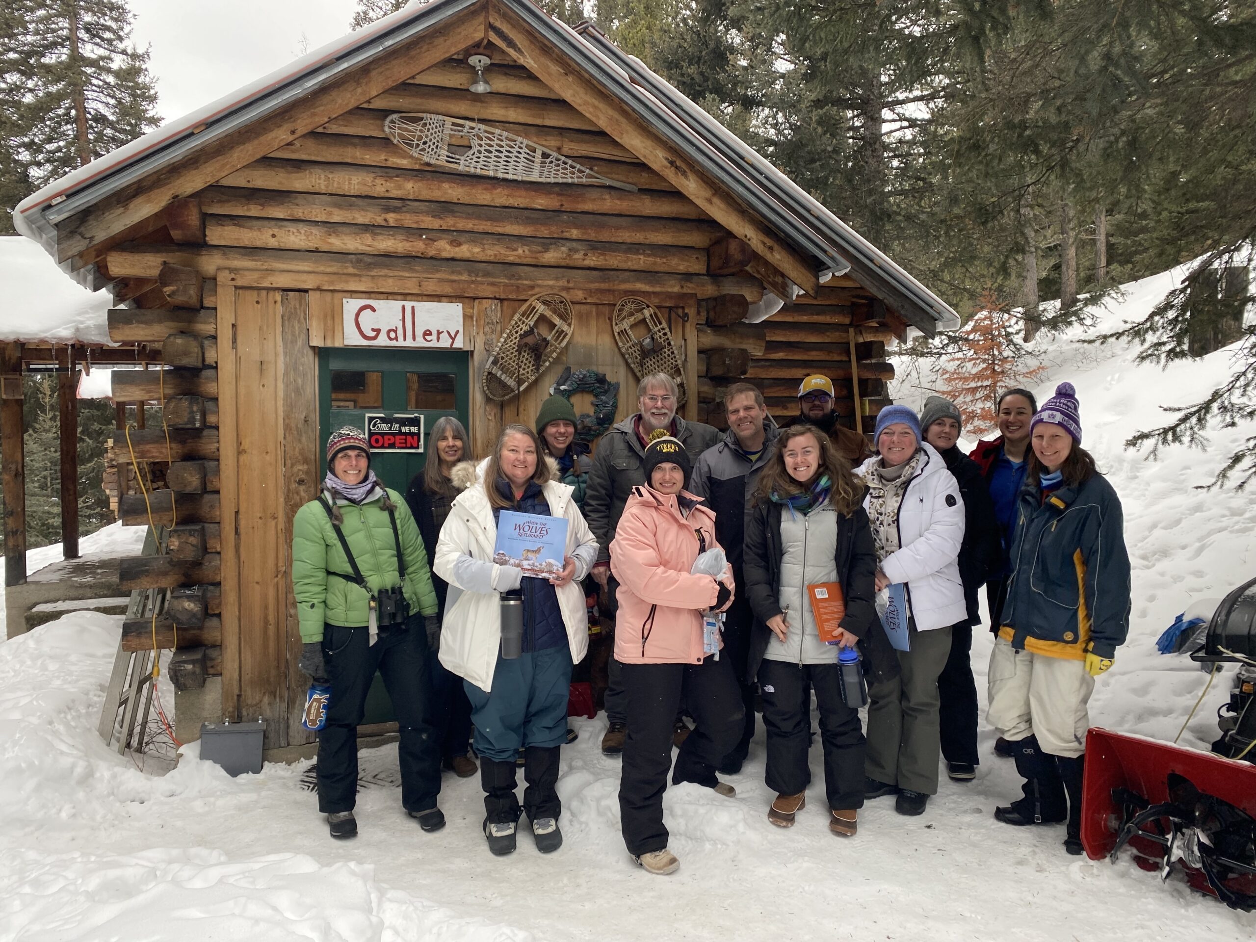 Group of people in front of log cabin