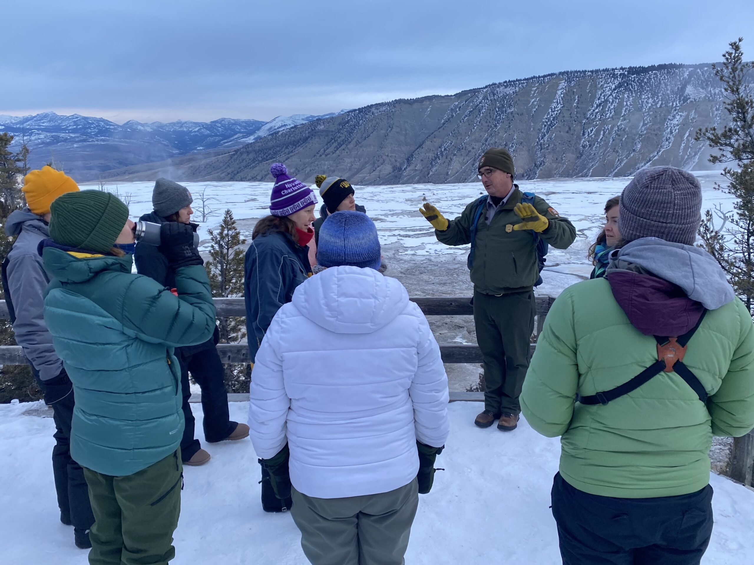 a group of people talking in snow