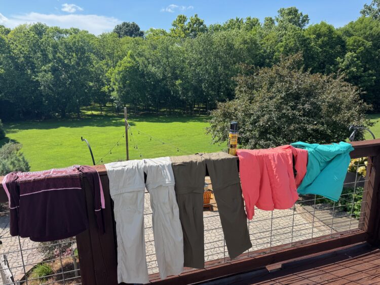 A row of clothes hanging out to dry after being sprayed with insecticides. 